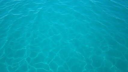 Abstract aerial view of turquoise water with soft wave patterns and gradient blue tones, evoking summer serenity.