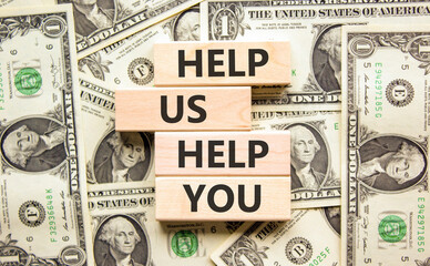 Help you symbol. Concept words phrase Help us help you on beautiful wooden blocks. Dollar bills....