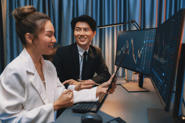 Businesswoman holding tablet on dynamic stock exchange statistic online showing to partners to...