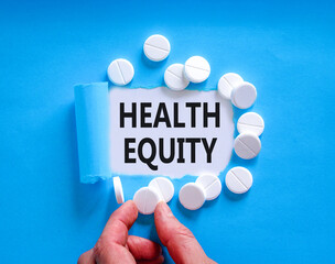 Health equity symbol. Concept words Health equity on beautiful white paper. White pills tablets....