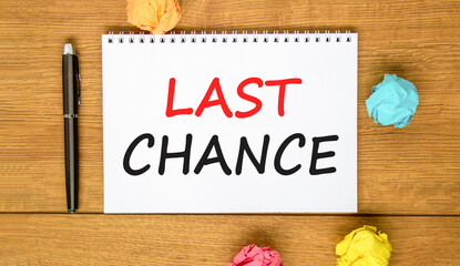 Last chance symbol. Concept word Last chance on beautiful white note. Black pen, colored paper....