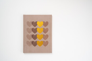 canvas on a white wall with gold hearts