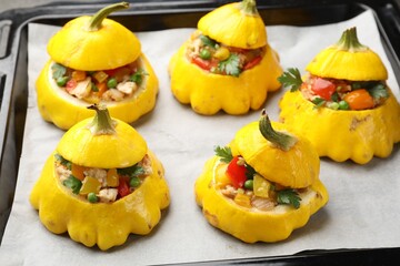 Tasty stuffed pattypan squashes on baking sheet, closeup