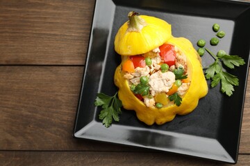 Tasty stuffed pattypan squash on wooden table, top view