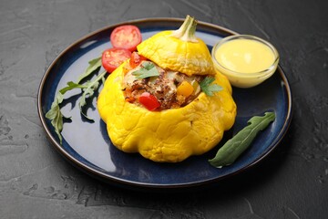 Tasty stuffed pattypan squash on black table, closeup