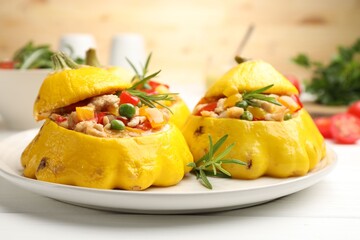 Tasty stuffed pattypan squashes on white wooden table, closeup