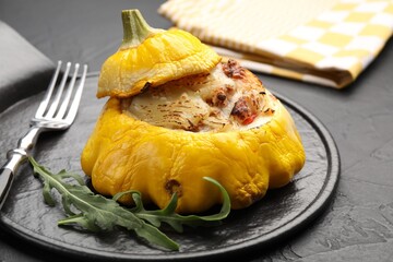 Tasty stuffed pattypan squash served on black table, closeup