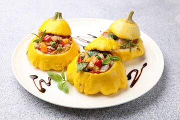 Tasty stuffed pattypan squashes on grey table, closeup