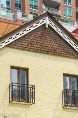 A yellow brick building in Yorkville features brown shingle gables, Toronto, Canada