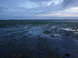 Grounded and keeled sail boats at low tide