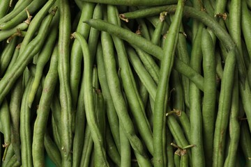 Fresh pea pods as background, top view