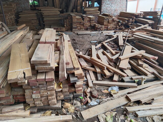 Stacks of wood planks in a lumberyard. Timber planks stacked to season, plank making factory