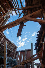 A unique perspective shot from inside a derelict barn, showing the dramatic collapse of the roof...