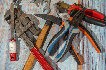 Hand tools lying on wooden table in workshop