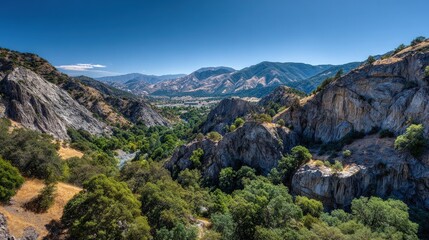 Obraz premium A vista of a rugged mountain valley with lush greenery.