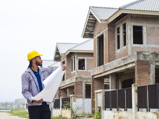 Professional architect and foreman wear head hat look meeting safety work teamuse check inspection...