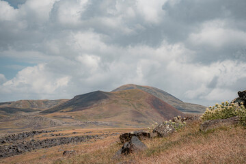 mountain landscape with horses and clouds