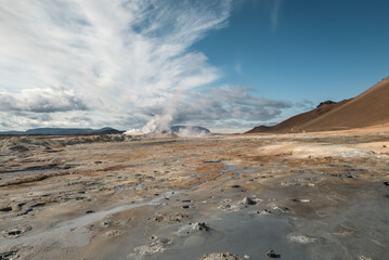 Geothermal Landscape with Steaming Geysers and Dramatic Clouds
