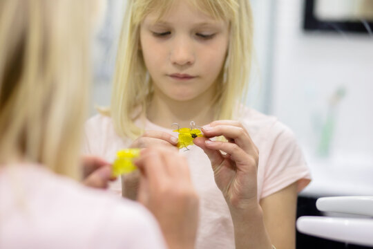 Confused child and dental plate
