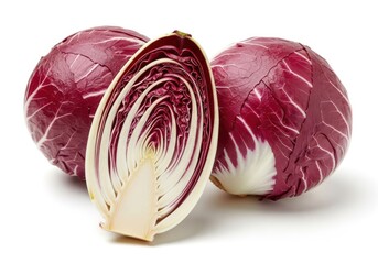 Fototapeta premium Three whole and halved radicchio vegetables on a white chicory purple