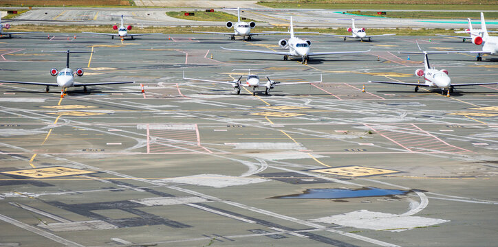 Aerial view of private planes parked on the airport runway