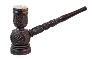 Ornate wooden smoking pipe with floral carvings and stone bowl on white background