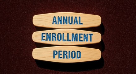 Annual Enrollment Period Signage Displayed on Wooden Blocks Against a Dark Backdrop Promoting Open Enrollment