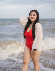 Woman young portrait asian fat chubby cute beautiful smile cheerful happy fun enjoy relax freedom in bikini swimwear body sexy plus size stand sea beach sunset ocean summer travel holiday evening time