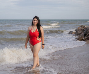 Woman young portrait asian fat chubby cute beautiful smile cheerful happy fun enjoy relax freedom in bikini swimwear body sexy plus size stand sea beach sunset ocean summer travel holiday evening time