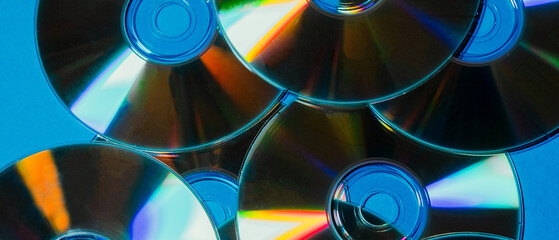 Reflective compact disc pattern with vibrant rainbow light reflections for nostalgic and retro-themed projects.