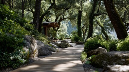 Wooden walkway through a lush garden with large rocks and trees.