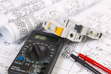 Electrical network protection and switching. Electrical engineering drawings, modular circuit breaker and digital multimeter. 