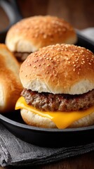Two succulent beef cheeseburgers with melted cheese and fresh lettuce sit invitingly in a cast-iron pan, ready to enjoy