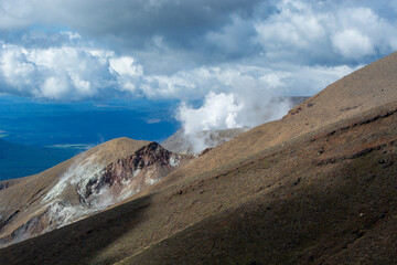 Scenic Volcanic Landscape with Steam and Clouds