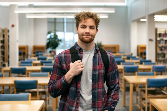 Male Student In Library Looks At Camera
