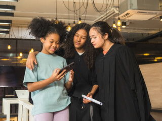 Kids children girl student group together smile cheerful happy fun enjoy photography taking selfie with frienship graduate in cap and gown success education congratulation for school academy campus