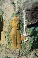 Carved Soldier Holding Sword on Rocky Surface