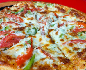 Closeup of pizza slices loaded with vegetables and cheese, food photography 