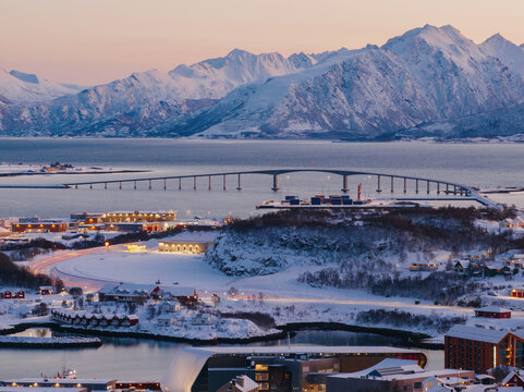 Stokmarknes bridge and snowy landscape at dusk in winter