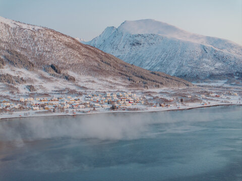 Snowy Village by Mountain and Water