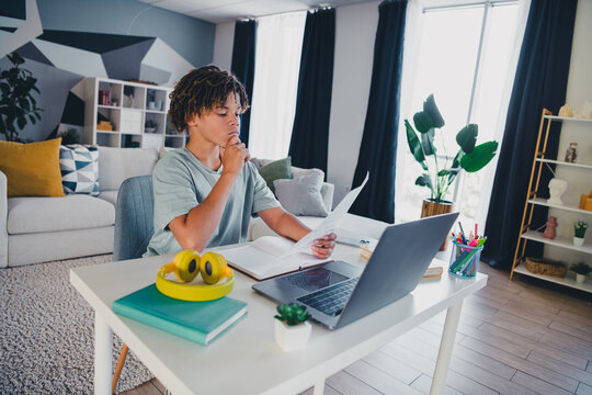 Young student studying at home in a comfortable and casual living space with a focus on learning and concentration