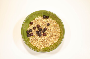 Close Up of Granola with Huckleberries in Green Bowl