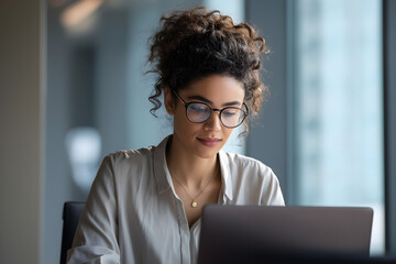 Focused Female Entrepreneur Working Indoors with Laptop in Modern Office - Inspiring Urban Business Lifestyle and Creative Productivity
