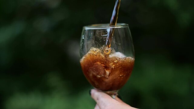 coke being poured into a glass