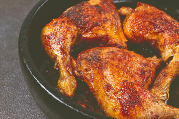 baked chicken legs, with crispy skin, served in a pan, rustic style, homemade, no people,