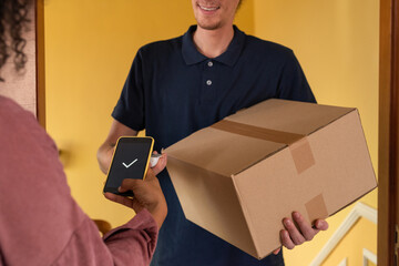 Anonymous delivery person accepting payment for goods from client