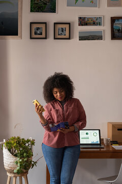Woman reading brochure and preparing to call customer care