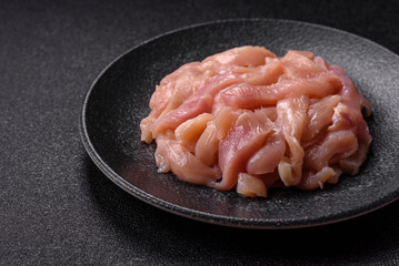 Raw chicken meat cut into strips, fresh fillet or breast slices. Chicken raw meat in pieces