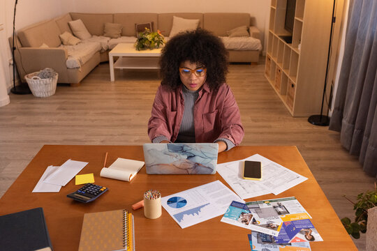 Woman replying on email on laptop at home office