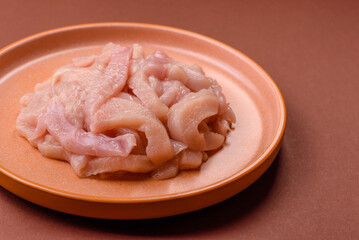 Raw chicken meat cut into strips, fresh fillet or breast slices. Chicken raw meat in pieces